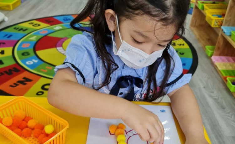 Early Years students are using Pom Poms as a fun way to learn